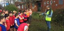 Children help out with school hedge