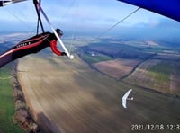 Pilot flies with a red kite over East Meon