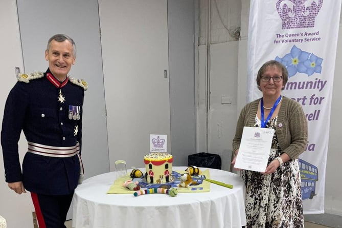 Nigel Atkinson, the Lord Lieutenant of Hampshire, presents the Queen's Award for Voluntary Service to Karen Murrell on behalf of Dementia-friendly Alton, December 1st 2022.