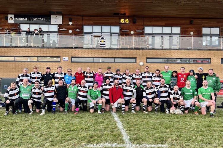 Farnham and London Irish Vets line up after their match beneath Adrian Myers’ No14 shirt