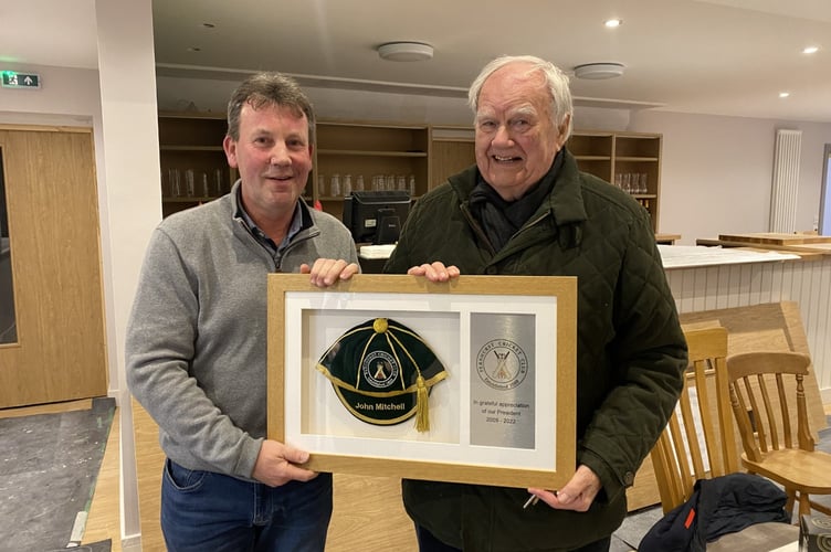 Fernhurst Cricket Club chairman Jon Meier presents John Mitchell with his framed honours cap