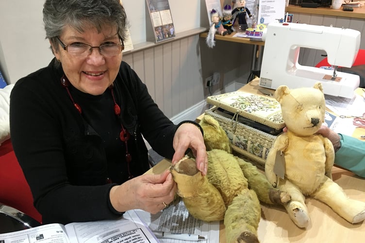 Seamstress Veronica Correa fixing a teddy with four poorly paws at Fernhurst Hub's first repair cafe