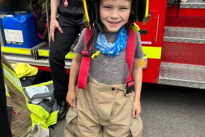 Bordon firefighters recruit seven-year-old Freddie at school fair