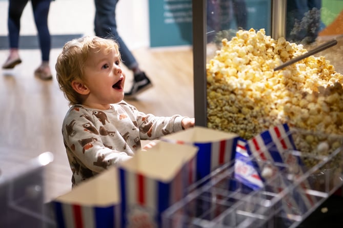 Boy looking at popcorn.