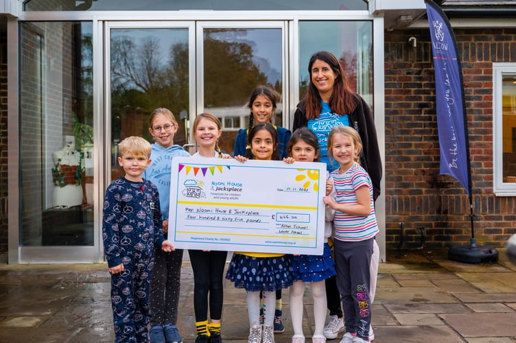 The student council at Alton School receives a souvenir giant cheque from Naomi House & Jacksplace.