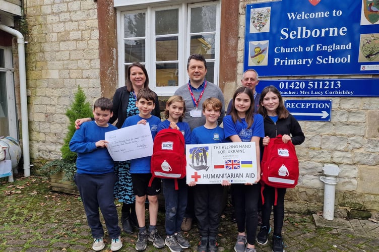 Students from Selborne C of E Primary School with their teacher and Simon and Nick Butler.