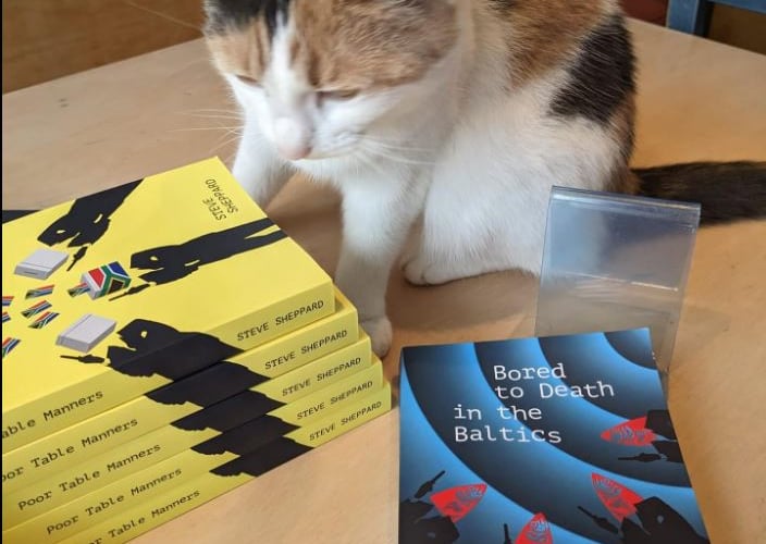 Steve's cat Charlie checking out copies of the new book