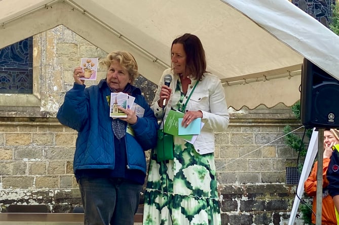 Sandi helps show off the locally designed postcards with the event's chair Fiona Grist