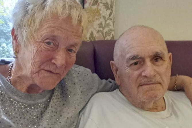 Fenella Clapham and her husband Brain at the care home in Colchester. Photo released November 10 2024. An OAP has been reunited with her dementia-suffering husband after being forced to spend two years travelling more than 260 miles to his care home.Fenella Clapham, 72, had been making the journey for Clacton-on-Sea, Essex, to Haslemere, Surrey, to see her husband Brian, 76. The couple were inseparable and had been married for 50 years before Brian was moved 130 miles away because there were no care places available near their home.However the loving couple have now been reunited as Brian, who has vascular dementia, has moved into a care home in Colchester - just 15 miles away.
